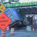 A truck after it became wedged underneath the East Street Railroad Bridge in Westwood Friday morning.